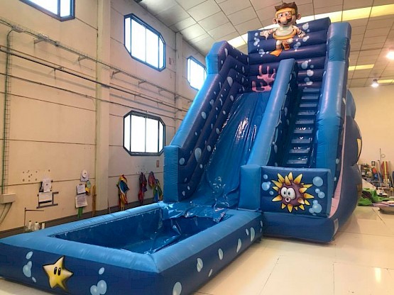 Un grand toboggan gonflable avec bassin, idéal pour camping
